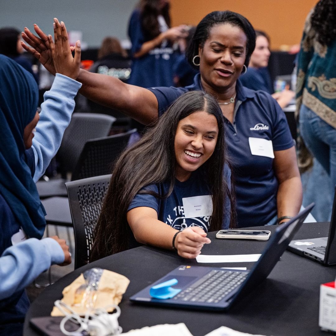 Casey Armstead cheering on high school young women at the Hack the Jobsite summer hackathon